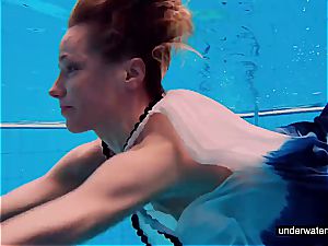 nubile girl Avenna is swimming in the pool